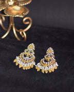 Gold jewelry with intricate designs on a black background