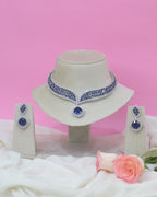 Jewelry set with earrings and a necklace on a pink background