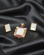 Jewelry set with pendant and earrings on black satin fabric