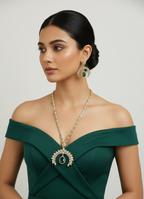 Woman wearing a green off-shoulder dress with jewelry on a plain background