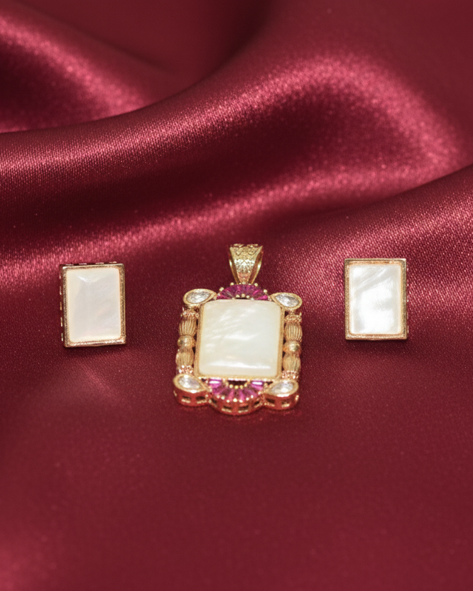 Jewelry set with pendant and earrings on burgundy satin fabric