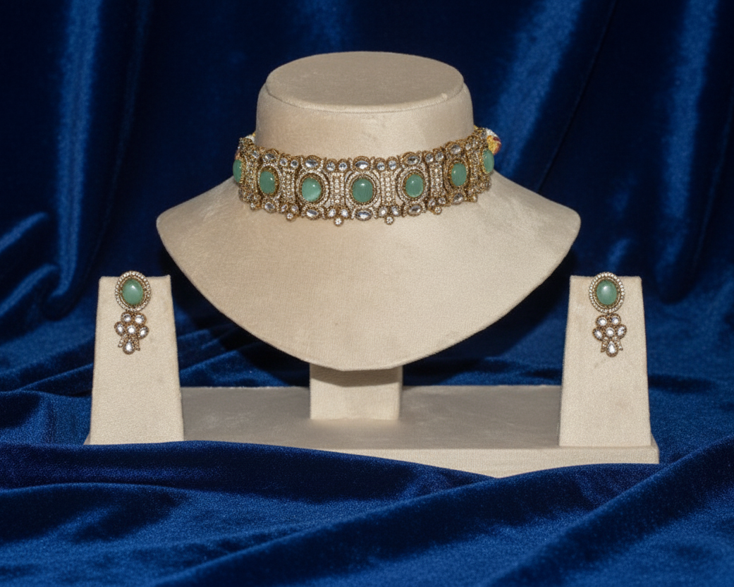 Jewelry set with a choker and earrings on a blue fabric background