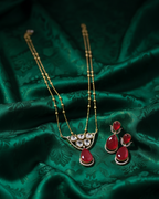 Jewelry set with a necklace and earrings on green fabric