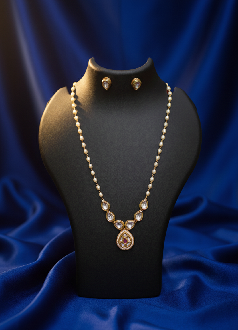 Jewelry set with necklace and earrings on a black mannequin against a blue fabric background