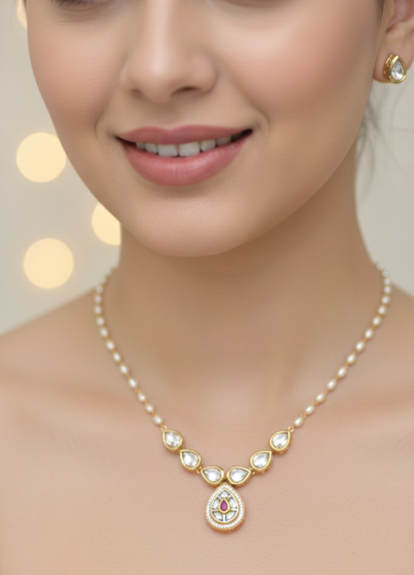 Pearl necklace with a pendant worn by a model against a neutral background