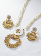 Gold necklace and earrings set on a white background