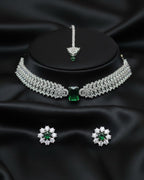 Jewelry set with necklace, earrings, and ring on a black satin background