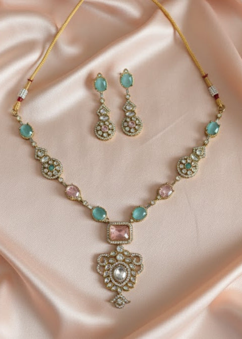Jewelry set with necklace and earrings on a pink satin background
