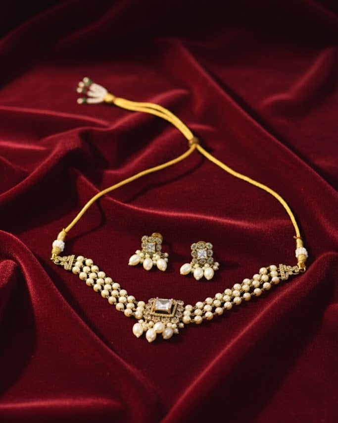 Jewelry set with necklace and earrings on a red fabric background