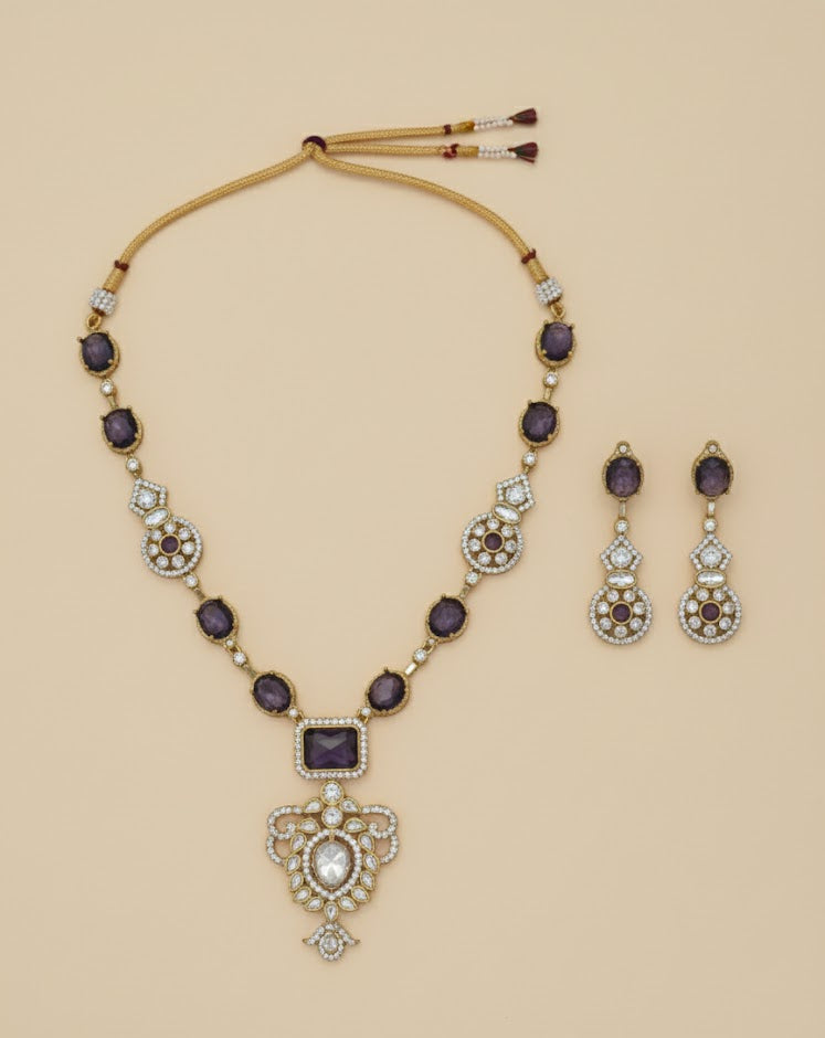 Ornate necklace and earrings set on a beige background