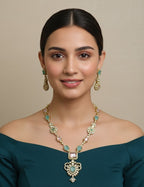 Woman wearing a gold and turquoise necklace with matching earrings on a beige background