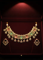 Ornate necklace with gemstones on a red velvet background