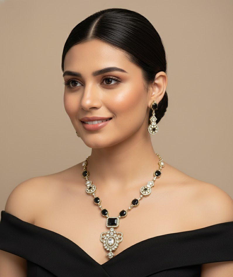 Woman wearing a black off-shoulder top and elegant jewelry on a beige background