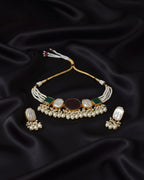 Jewelry set with necklace and earrings on black satin fabric