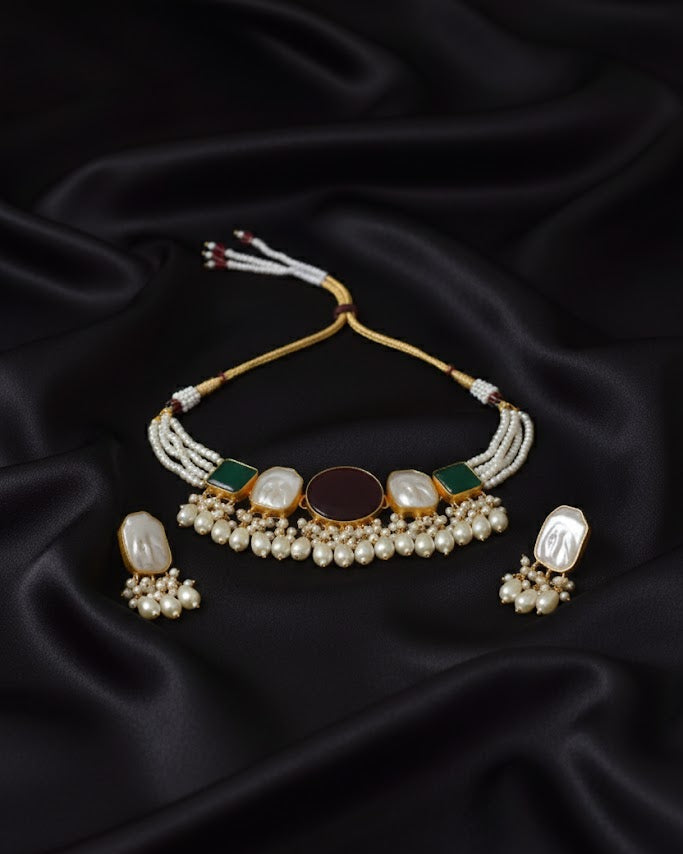 Jewelry set with necklace and earrings on black satin fabric