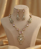 Jewelry set including necklace and earrings on a mannequin bust with a gold background