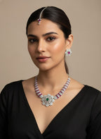 Woman wearing a luxurious necklace, earrings, and headpiece against a beige background